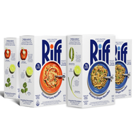 Four Riff chef-crafted meal kit boxes shown from an angle with their "Feeling creative?" side panels visible, two Coconut Curry Noodles boxes and two Sesame Ginger Noodles boxes, each with fresh produce tips and a photo of the plated dish.