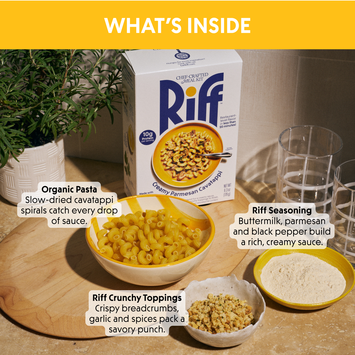 "What's Inside" panel for Riff Creamy Parmesan Cavatappi showing a box of the meal kit next to a bowl of dry cavatappi pasta, a dish of seasoning, and a bowl of crunchy topping, each labeled with a description of its role in the dish.