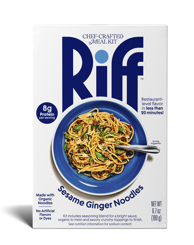 Front of a Riff Sesame Ginger Noodles chef-crafted meal kit box shown straight-on, featuring a blue bowl of noodles topped with sesame seeds and vegetables and a spoon resting in the dish.