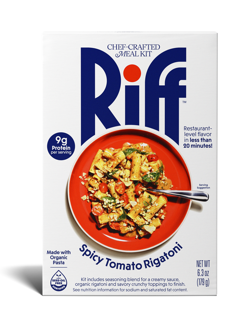 Front of a Riff Spicy Tomato Rigatoni chef-crafted meal kit box shown straight-on, featuring a red plate of rigatoni pasta with cherry tomatoes, greens, and crumbled topping, with a spoon resting in the dish.