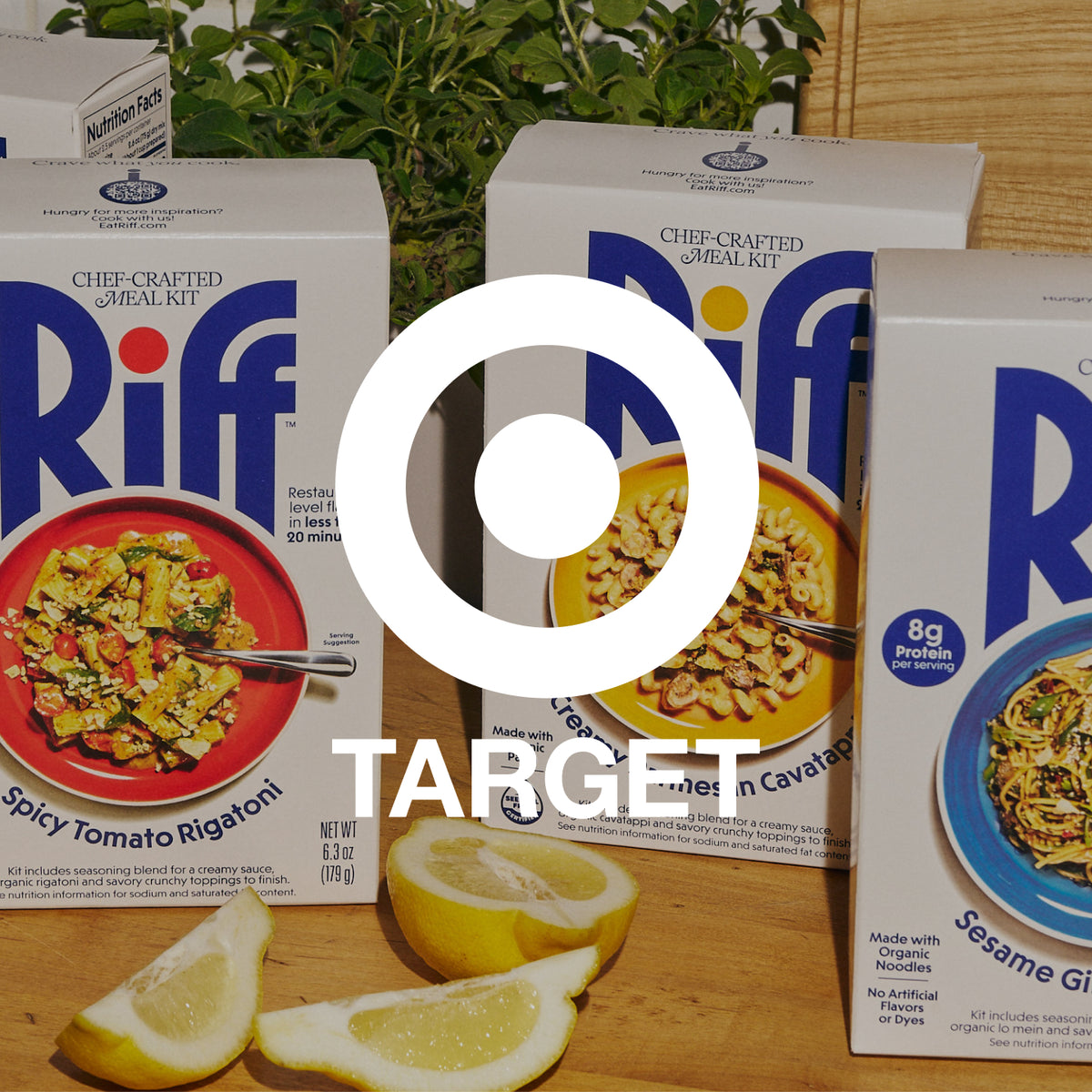Three Riff chef-crafted meal kit boxes on a wooden counter with lemon wedges, overlaid with a large white Target logo and bullseye icon.