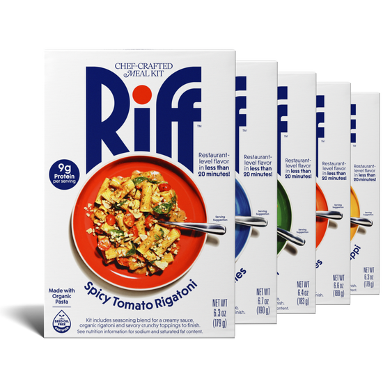 Five Riff chef-crafted meal kit boxes fanned out in a row, with a box of Spicy Tomato Rigatoni in front showing a red plate of pasta and partial views of the other four flavor boxes behind it.