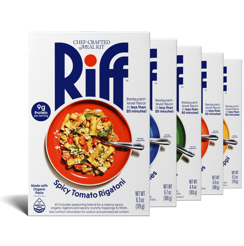 Five Riff chef-crafted meal kit boxes fanned out in a row, with a box of Spicy Tomato Rigatoni in front showing a red plate of pasta and partial views of the other four flavor boxes behind it.