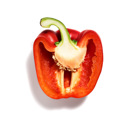 A red bell pepper cut in half showing its seeds and core, on a transparent background.